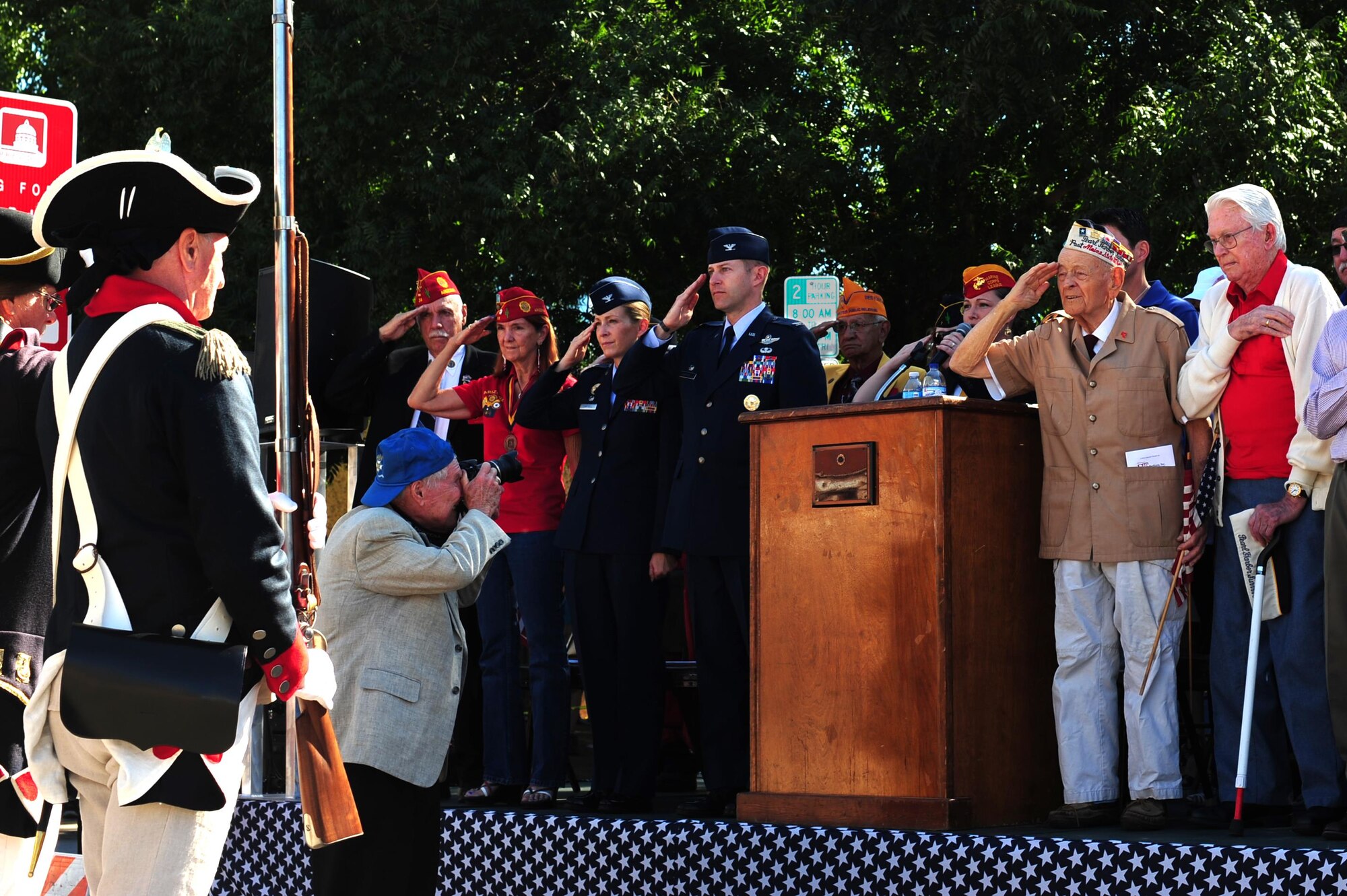 U.S. Air Force Col. Scott Campbell, 355th Fighter Wing commander, and his wife Col. Kim Campbell, 612th Theater Operations Group commander, join dignitaries as they render a salute for the National Anthem during the Tucson Veterans Day Parade in Tucson, Ariz., Nov. 11, 2016. The parade is an annual event that honors U.S. service members past and present. (U.S. Air Force photo by Airman Nathan H. Barbour)
