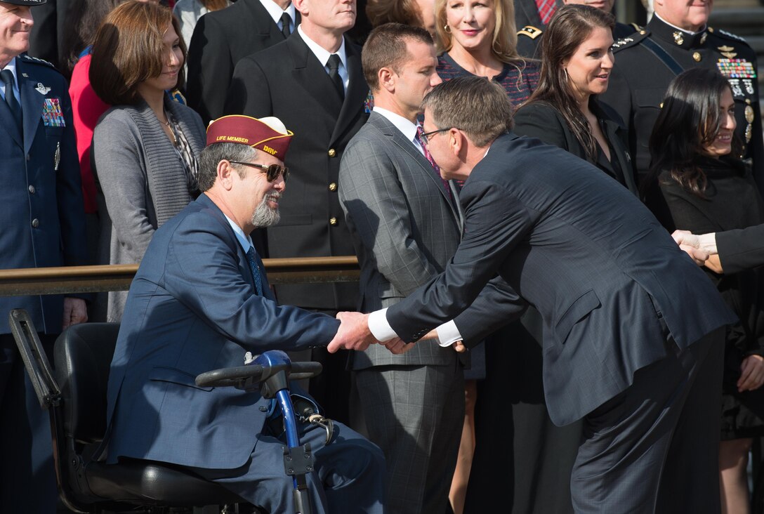 Defense Secretary Ash Carter shakes hands with a disabled veteran before a wreath-laying ceremony at the Tomb of the Unknown Soldier at Arlington National Cemetery, Arlington, Va., Nov. 11, 2016 DoD photo by Army Sgt. Amber I. Smith