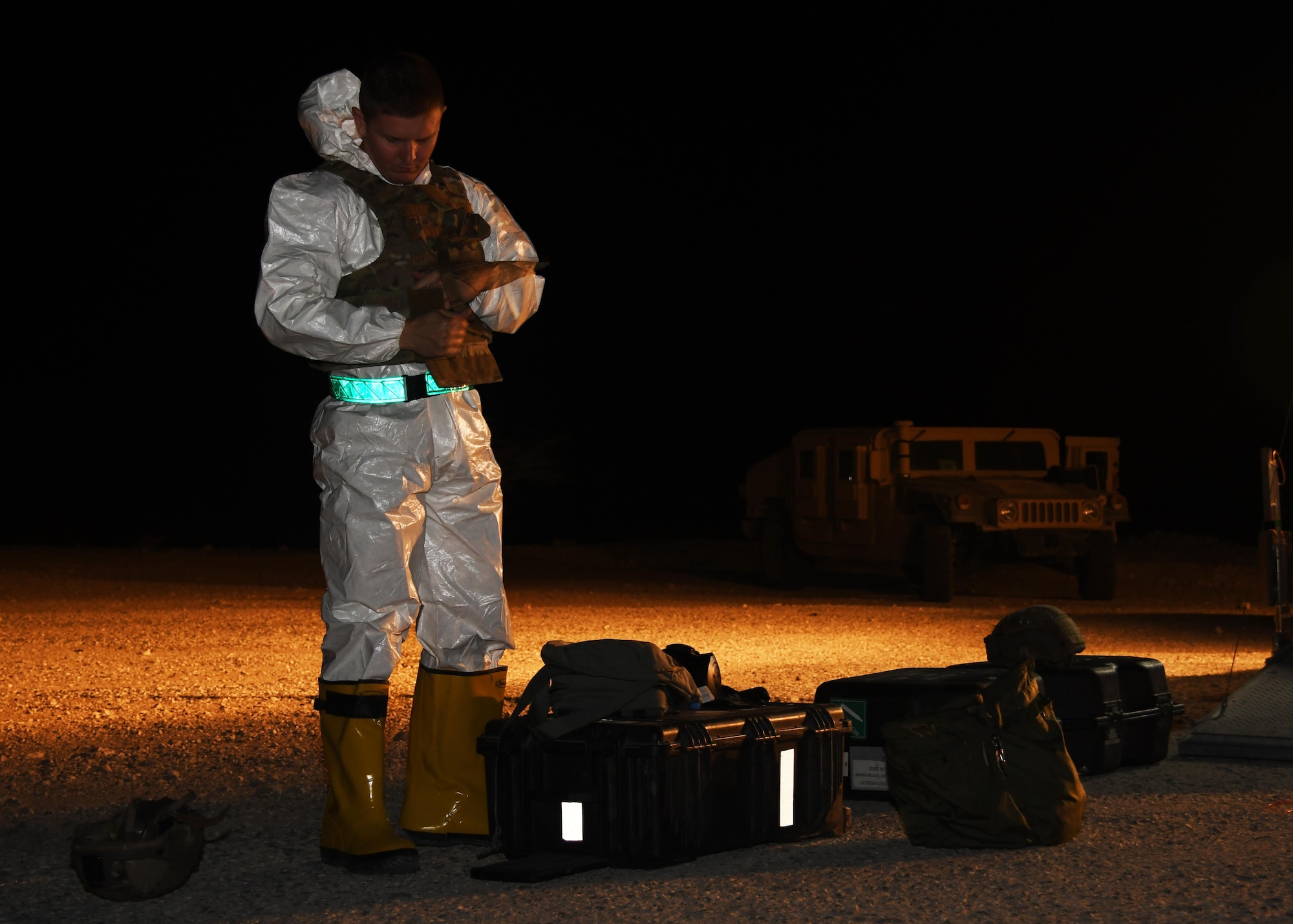 U.S. Air Force Tec. Sgt. Zachary Holschuh, 379th Expeditionary Civil Engineer Squadron explosive ordinance disposal operations section chief, dons his personal protective equipment at Al Udeid Air Base, Qatar, Nov. 9, 2016. Holschuh is a member of the EOD team that participated in an exercise involving a stolen vehicle with possible radiological material. (U.S. Air Force photo by Senior Airman Miles Wilson)
