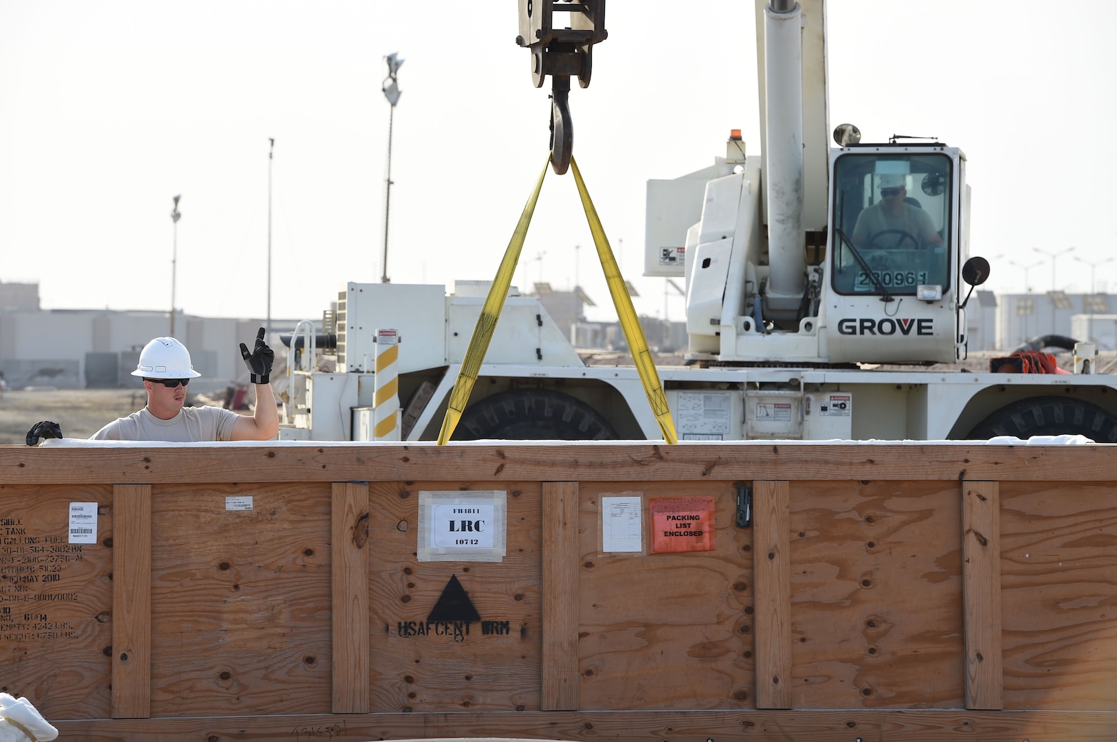 Tech. Sgt. Justin, 380th Expeditionary Civil Engineer Squadron, directs Tech. Sgt. Joshua, 380th ECES, in moving a new fuel bladder from the shipping container to an empty berm at an undisclosed location in Southwest Asia, Nov. 9, 2016. This bladder is the first of four scheduled for replacement over the next month. (U.S. Air Force photo by Tech. Sgt. Christopher Carwile) 