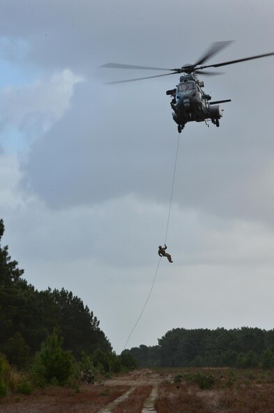 A 57th Rescue Squadron Airman rappels from a French air force EC-725 Caracal assigned to the 1/67 Pyrénées Squadron, Nov. 9 during Exercise Salamander at Cazaux Air Force Base, France. Two HH-60G Pave Hawk helicopters assigned to the 56th RQS and approximately 100 Airmen from the 56th and 57th RQSs are involved in the joint training exercise with French Air Force members and helicopters. (U.S. Air Force photo/Master Sgt. Eric Burks)