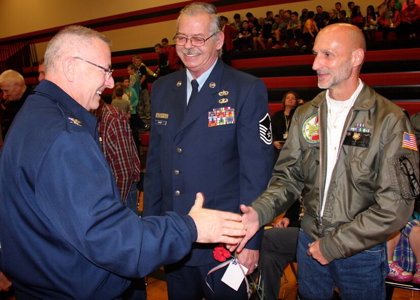 Before taking the podium to recognize Veterans Day while speaking at Highland Junior High School, the commander of the 932nd Airlift Wing, Col. Jonathan Philebaum (at left), made a point to reach out to some of the veterans he saw there from past United States military history, to thank them for serving America and for remembering others on this day.  Col. Philebaum spoke to an estimated crowd of over 700 people on November 10, 2016 in Highland, Ill.  (U.S. Air Force photo by Lt. Col. Stan Paregien)