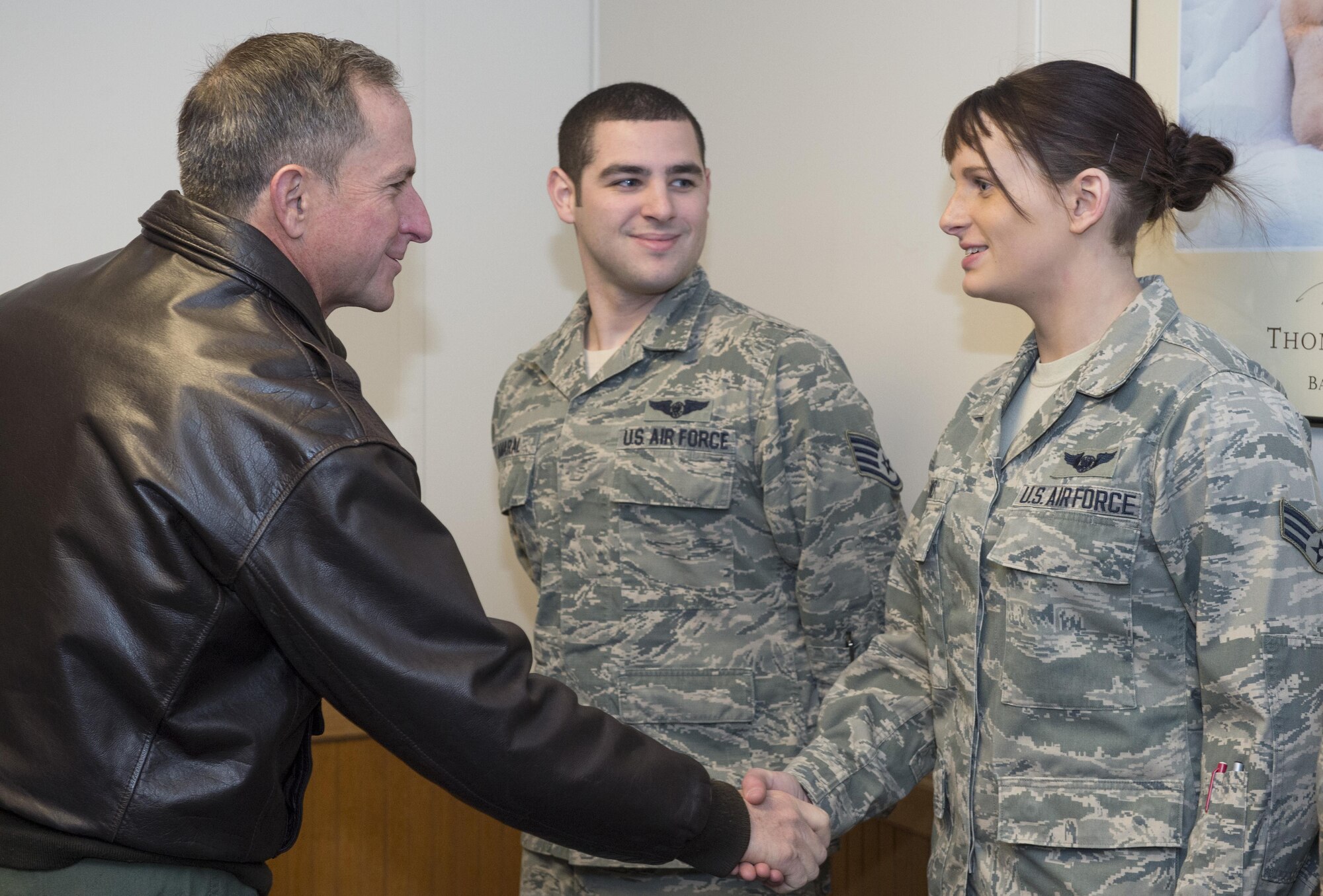 Air Force Chief of Staff Gen. David L. Goldfein presents exemplary Airmen with a challenge coin at Joint Base Elmendorf-Richardson, Alaska, Nov. 10, 2016. During his Pacific tour, Goldfein visited JBER and shared his priorities of revitalizing squadrons, strengthening joint leaders and teams, and multi-domain command and control. 