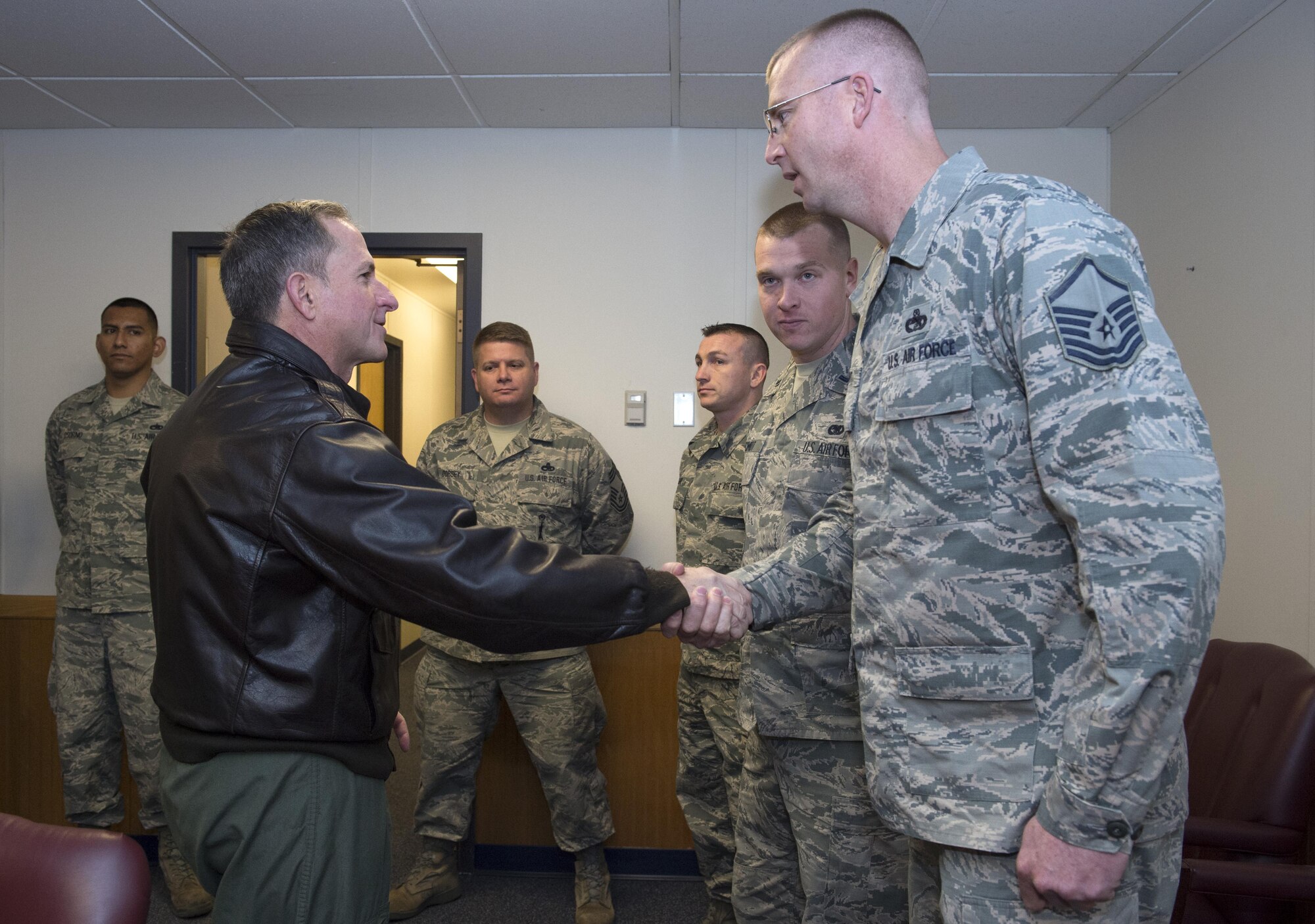 Air Force Chief of Staff Gen. David L. Goldfein presents exemplary Airmen with a challenge coin at Joint Base Elmendorf-Richardson, Alaska, Nov. 10, 2016. During his Pacific tour, Goldfein visited JBER and shared his priorities of revitalizing squadrons, strengthening joint leaders and teams, and multi-domain command and control. 