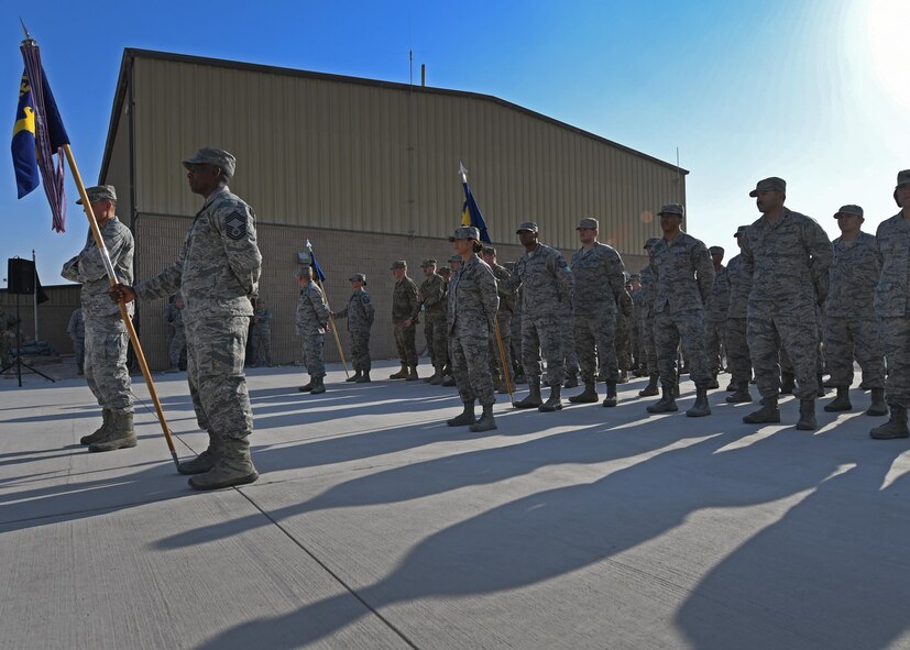 Airmen stand in formation before a Veterans Day retreat ceremony at Al Udeid Air Base, Qatar, Nov. 11, 2016. Veterans Day, originally known as Armistice Day, commemorates the service and sacrifice of U.S. veterans, both past and present. (U.S. Air Force photo by Senior Airman Miles Wilson)