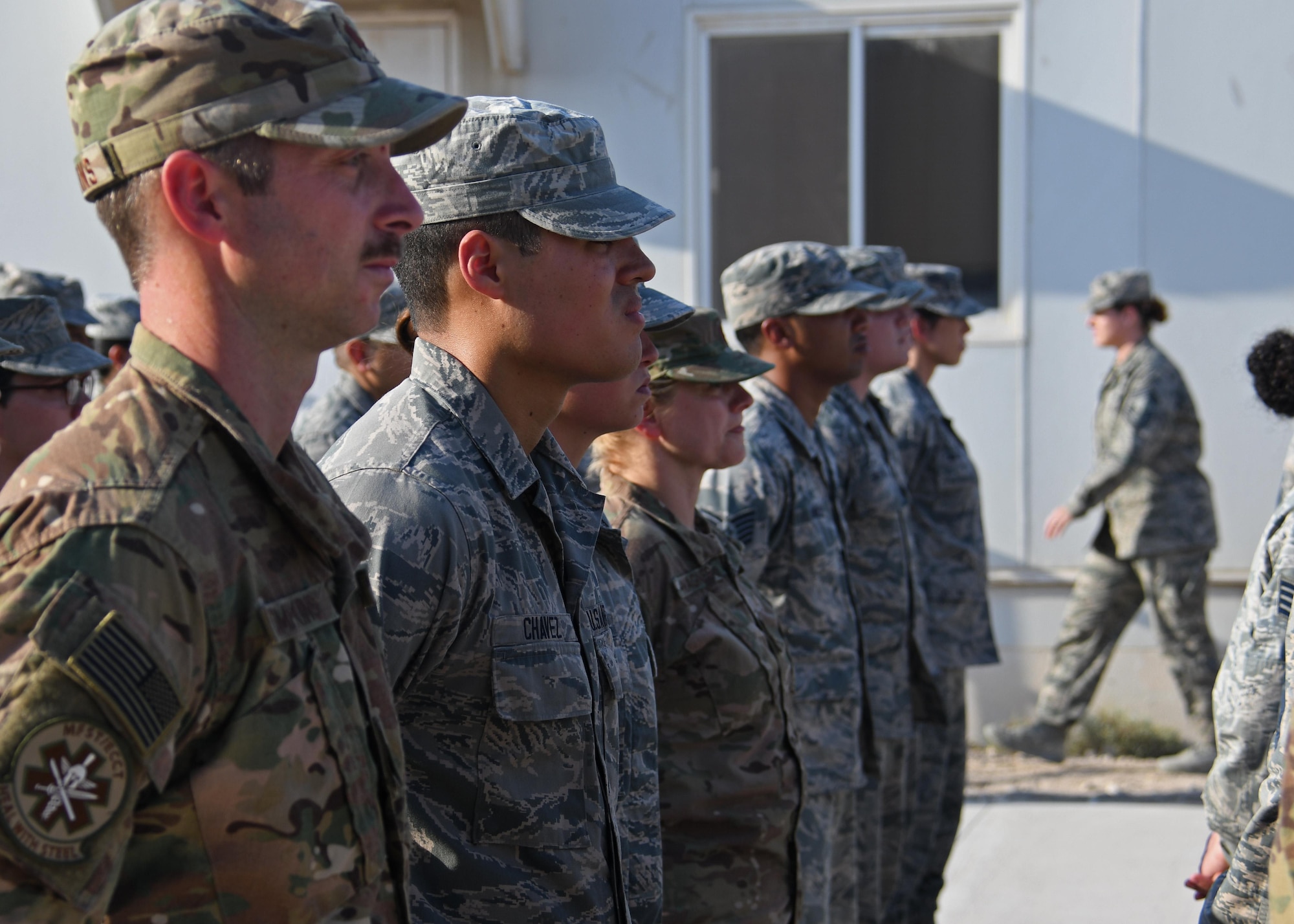 Airmen stand in formation before a Veterans Day retreat ceremony at Al Udeid Air Base, Qatar, Nov. 11, 2016. Veterans Day, originally known as Armistice Day, commemorates the service and sacrifice of U.S. veterans, both past and present. (U.S. Air Force photo by Senior Airman Miles Wilson)