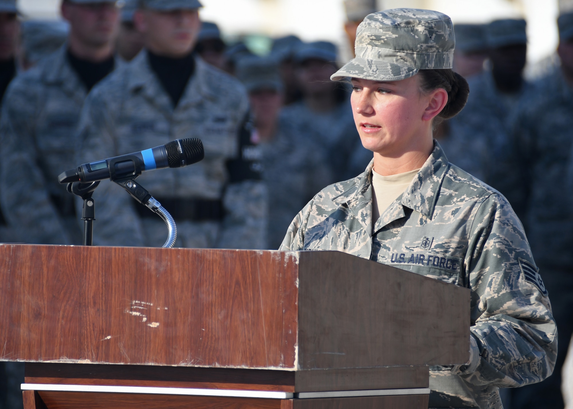 U.S. Air Force Staff Sgt. April Young, 379th Expeditionary Medical Group intra-theatre care program NCO in-charge, narrates during the Veterans Day retreat ceremony at Al Udeid Air Base, Qatar, Nov. 11, 2016. Veterans Day is a day that honors the service and sacrifice of U.S. veterans, both past and present. (U.S. Air Force photo by Senior Airman Miles Wilson)