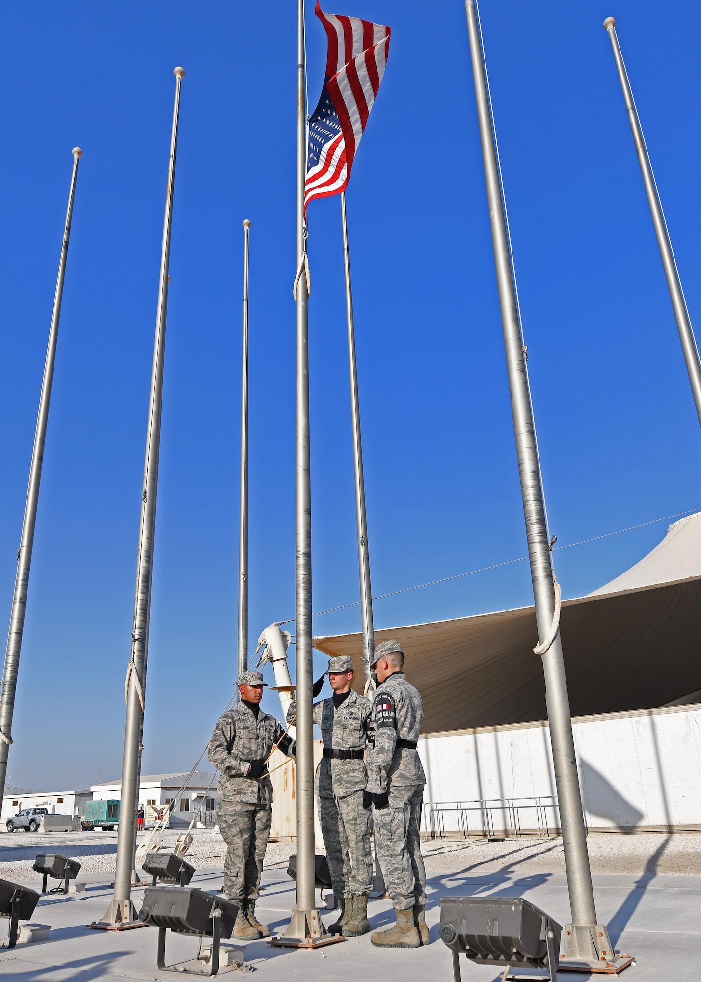 The base Honor Guard lowers the U.S. flag during a Veterans Day retreat ceremony held at Al Udeid Air Base, Qatar, Nov. 11, 2016. The colors were retired in honor of all U.S. veterans, both past and present. (U.S. Air Force photo by Senior Airman Miles Wilson)