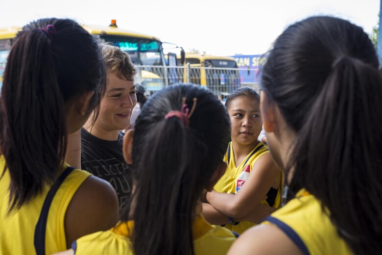 U.S. Marine Corps Lance Cpl. Meagan Baker, a heavy equipment operator with Marine Wing Support Squadron (MWSS) 171, interacts with Sekolah Menengah Eben Haezar Manado High School students in Manado, Indonesia, Nov. 9, 2016. As part of a community relations event, the visit offered service members the opportunity to engage in cultural exchanges and build relationships within the local community. The students were afforded the opportunity to ask the Marines and Sailors questions before U.S. Marine Corps Gunnery Sgt. Matthew Nightwine, quality assurance chief, Cpl. Jonathan Castillo and Cpl. Zachary Gustin, airframe mechanics with VMFA (AW) 225, demonstrated Marine Corps Martial Arts Program techniques. (U.S. Marine Corps photo by Cpl. Aaron Henson)