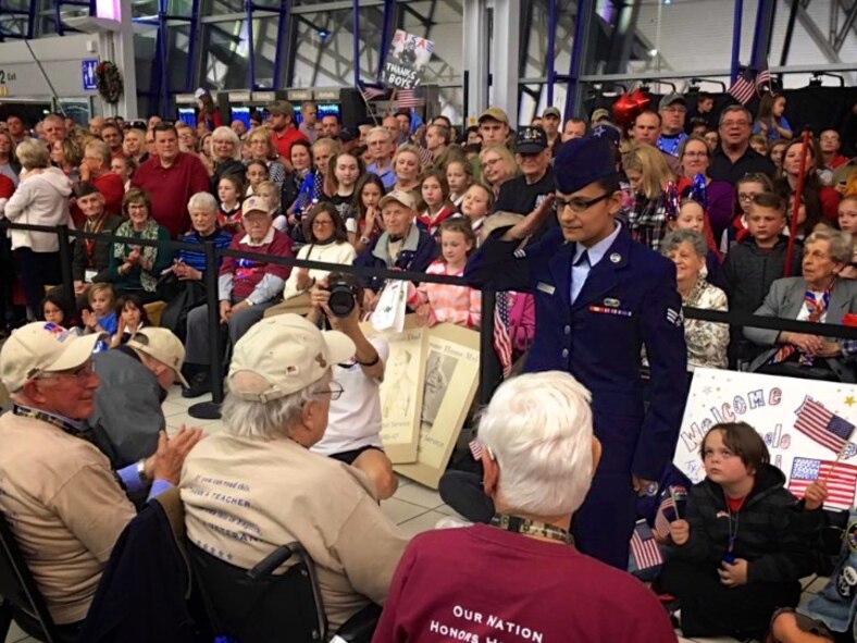 Senior Airman Maria Tremblay, 932nd Operation Group, salutes a returning World War II veteran at the conclusion of the November 12 Honor Flight at the Saint Louis Airport.  She and other volunteers from the wing gave of their time to thank and remember those veterans who served many years before them.  (U.S. Air Force photo by Lt. Col. Stan Paregien)