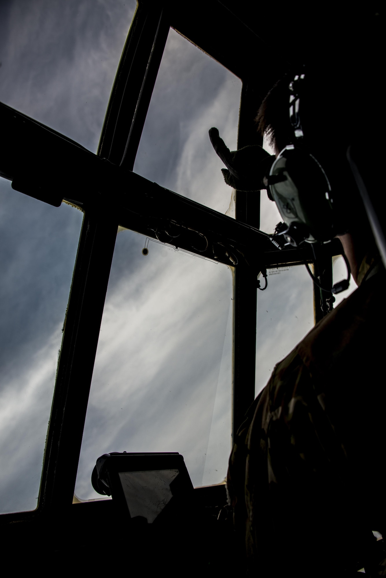 Capt. Andrew Bryant, 1st Special Operations Squadron aircraft commander, points out the window of an MC-130H Combat Talon II during low-level air intercept (AI) training with three F-16Cs from the 35th Fighter Squadron at Kunsan Air Base, Oct. 19, 2016. This opportunity provided the 1st SOS and 35th FS crews with invaluable AI training. (U.S. Air Force photo by Capt. Jessica Tait)