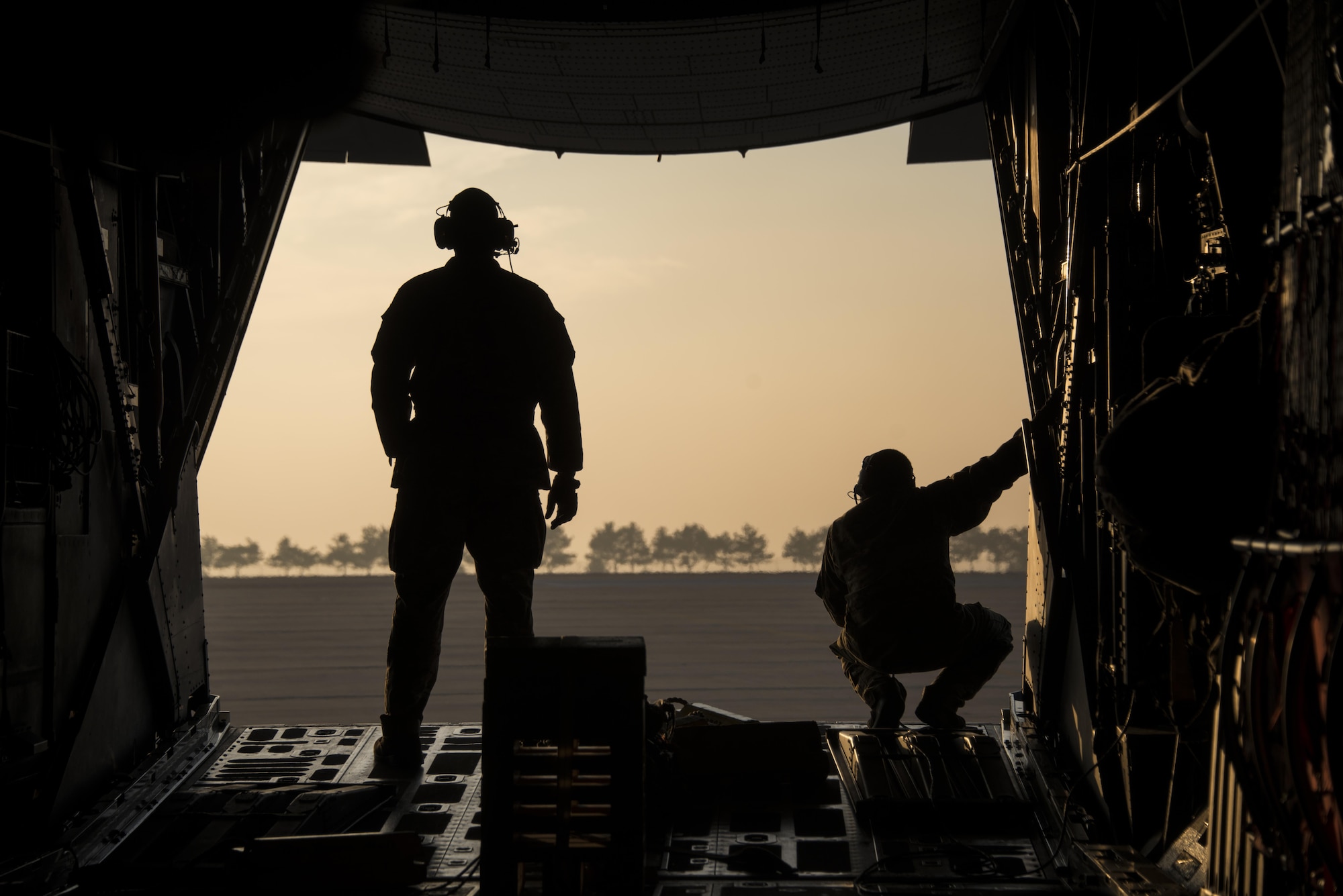 Staff Sgts. Craig Bailey and Shaun LaRue, 1st Special Operations Squadron loadmasters, looks out the window of an MC-130H Combat Talon II during low-level air intercept (AI) training with three F-16C Fighting Falcons from the 35th Fighter Squadron at Kunsan Air Base, Oct. 19, 2016. This opportunity provided the 1st SOS and 35th FS crews with invaluable AI training. (U.S. Air Force photo by Capt. Jessica Tait)