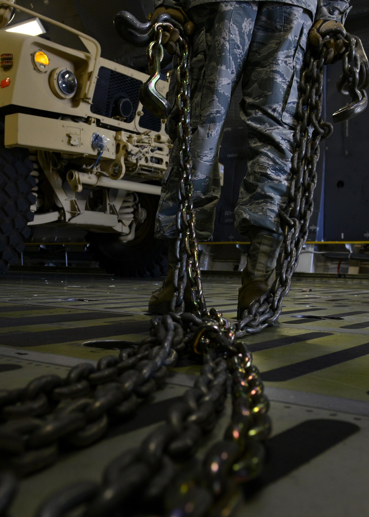 A 724th Air Mobility Squadron Airman secures an all-terrain vehicle on a C-5M Super Galaxy at Aviano Air Base, Italy on Nov. 8, 2016. Thirteen 724th AMS Airmen loaded and secured the vehicles and other cargo. (U.S. Air Force photo by Senior Airman Cary Smith)