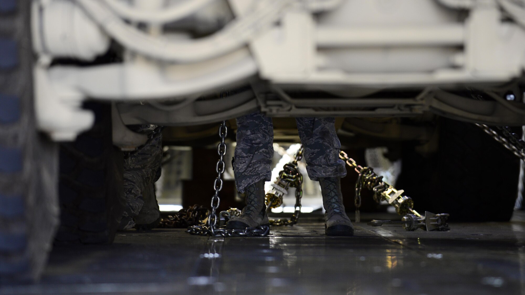 Airmen from the 724th Air Mobility Squadron secure all-terrain vehicles inside a C-5M Super Galaxy with chains at Aviano Air Base, Italy on Nov. 8, 2016. The process took 13 Airmen approximately two hours to complete before the C-5M was prepared to takeoff for Iraq. (U.S. Air Force photo by Senior Airman Cary Smith)
