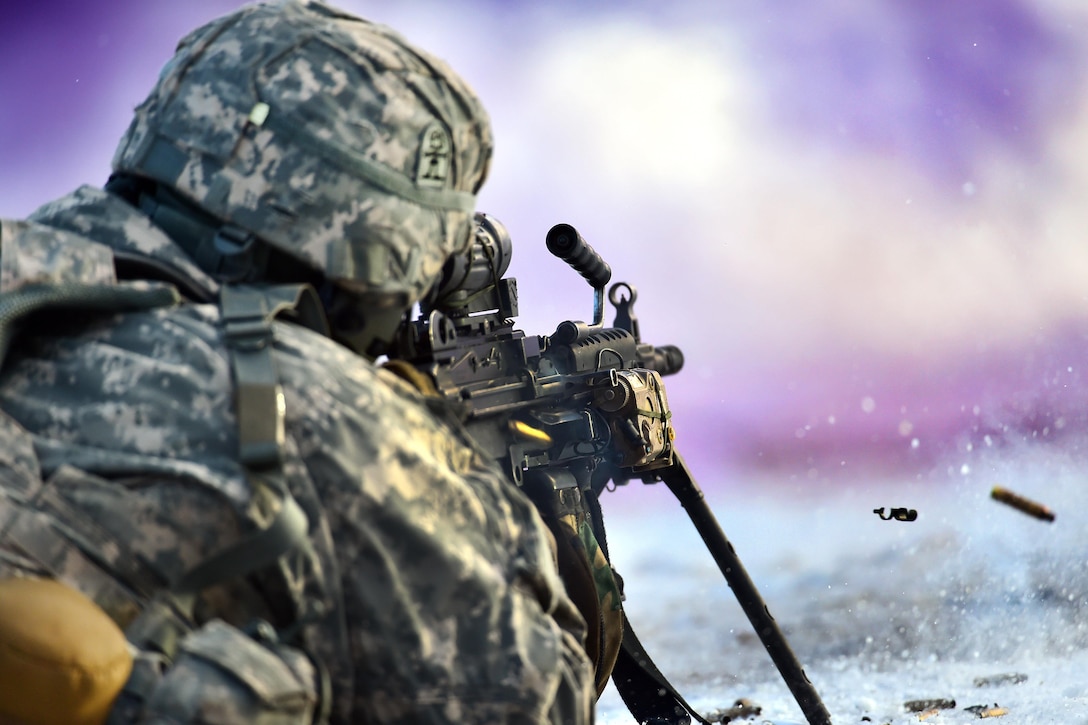 A soldier fires his machine gun under the cover of smoke during a live-fire exercise at Joint Base Elmendorf-Richardson, Alaska, Nov. 8, 2016. Air Force photo by Justin Connaher
