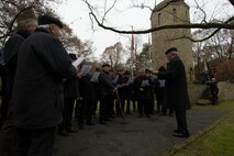 A men's choir group sings during a German National Day of Mourning observance ceremony at the Kolmeshöhe Military Cemetery in Bitburg, Germany, Nov. 13, 2016. The day, known as Volkstrauertag in German, observes the human cost of war and was established following the conclusion of the First World War. (U.S. Air Force photo by Staff Sgt. Joe W. McFadden)