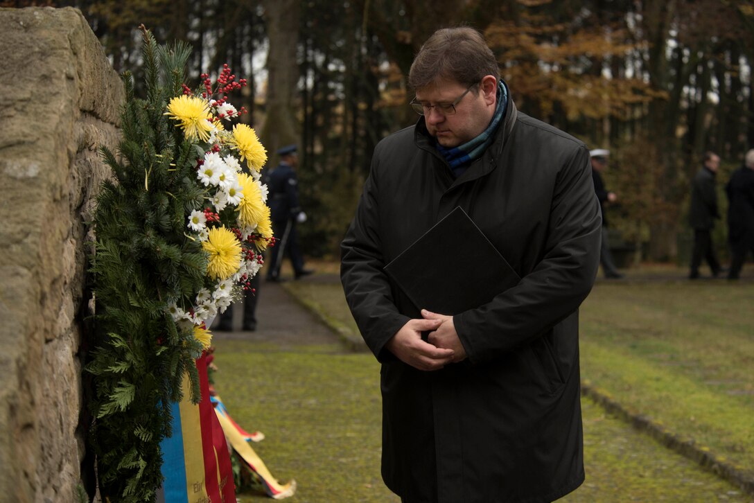 Joachim Kandels, mayor of the city of Bitburg, Germany, reviews a wreath after a German National Day of Mourning observance ceremony at the Kolmeshöhe Military Cemetery in Bitburg, Germany, Nov. 13, 2016.The day, known as Volkstrauertag in German, observes the human cost of warfare and suffering. (U.S. Air Force photo by Staff Sgt. Joe W. McFadden)