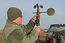 Tech. Sgt. James Pomar, 5th Operations Support Squadron missions NCO in charge, attaches a wind mast to a tactical meteorological equipment base at Minot Air Force Base, N.D., Nov. 8, 2016. The equipment provides weather flight with wind and speed direction data to inform operations personnel of inclement weather. (U.S. Air Force photo/Airman 1st Class Jessica Weissman)