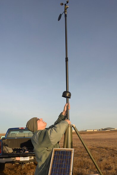 Tech. Sgt. James Pomar, 5th Operations Support Squadron missions NCO in charge, sets up tactical meteorological equipment on the airfield on Minot Air Force Base, N.D., Nov. 8, 2016. The equipment is a transportable system used as a back-up data collection source to ensure weather conditions are suitable for flight and ground operations. (U.S. Air Force photo/Airman 1st Class Jessica Weissman)