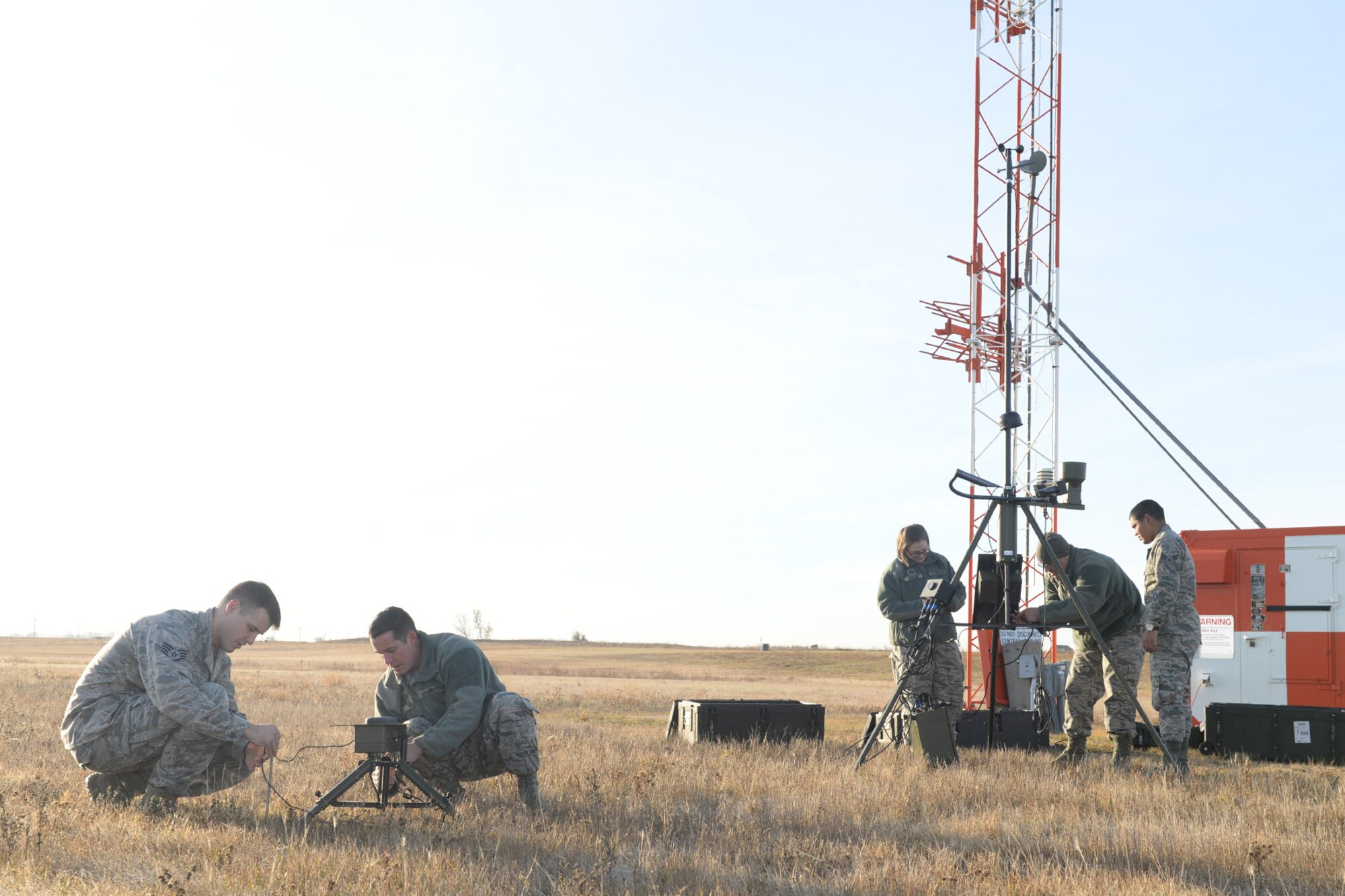 Airmen from the 5th Operations Support Squadron weather operations flight set up tactical meteorological equipment on the airfield at Minot Air Force Base, N.D., Nov. 8, 2016. The weather flight supports Team Minot with weather condition updates for flight operations, ground operations and weapons movements. (U.S. Air Force photo/Airman 1st Class Jessica Weissman)