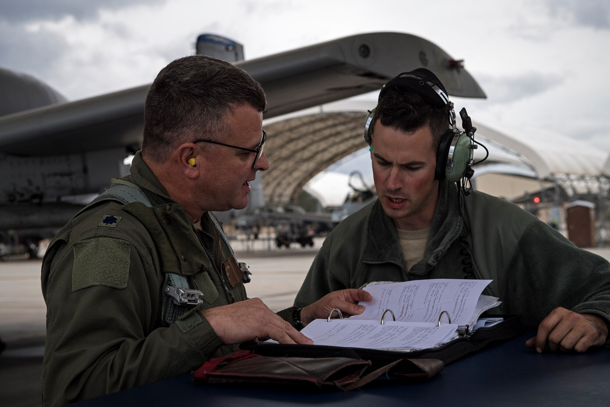 U.S. Air Force Reserve Lt. Col Robert Sweet, 476th Fighter Group A-10C Thunderbolt II pilot and Staff Sgt. Christopher Fisher, 74th Aircraft Maintenance Unit crew chief, check paperwork before a flight during a surge exercise, Nov. 9, 2016, at Moody Air Force Base, Ga. Moody's 476th and 23d Fighter Groups, 23d Maintenance Group and geographically seperated units from the 93d Air Ground Operations Wing integrated during the exercise, performing non-stop operations that tested the A-10's maintenance and aviation capabilities to enhance mission readiness. (U.S. Air Force photo by Airman 1st Class Janiqua P. Robinson) 