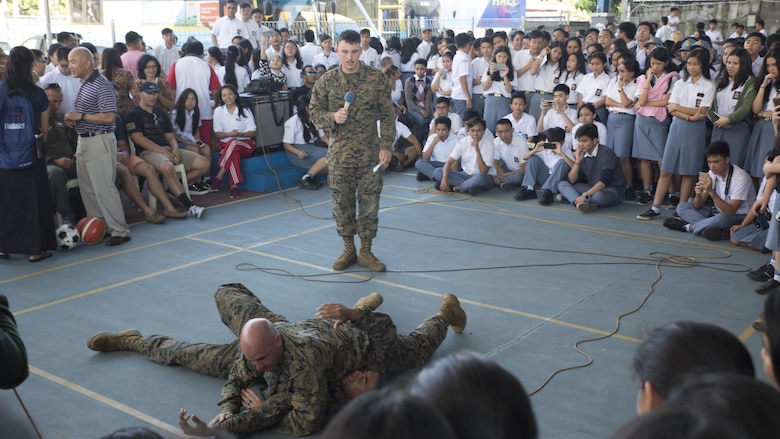 U.S. Marine Corps Gunnery Sgt. Matthew Nightwine, quality assurance chief, and Cpl. Jonathan Castillo, an airframe mechanic with Marine All-Weather Fighter Attack Squadron 225, demonstrate Marine Corps Martial Arts Program techniques during a visit at Sekolah Menengah Eben Haezar Manado High School in Manado, Indonesia, Nov. 9, 2016. As part of a community relations event, the visit offered service members the opportunity to engage in cultural exchanges and build relationships within the local community. 