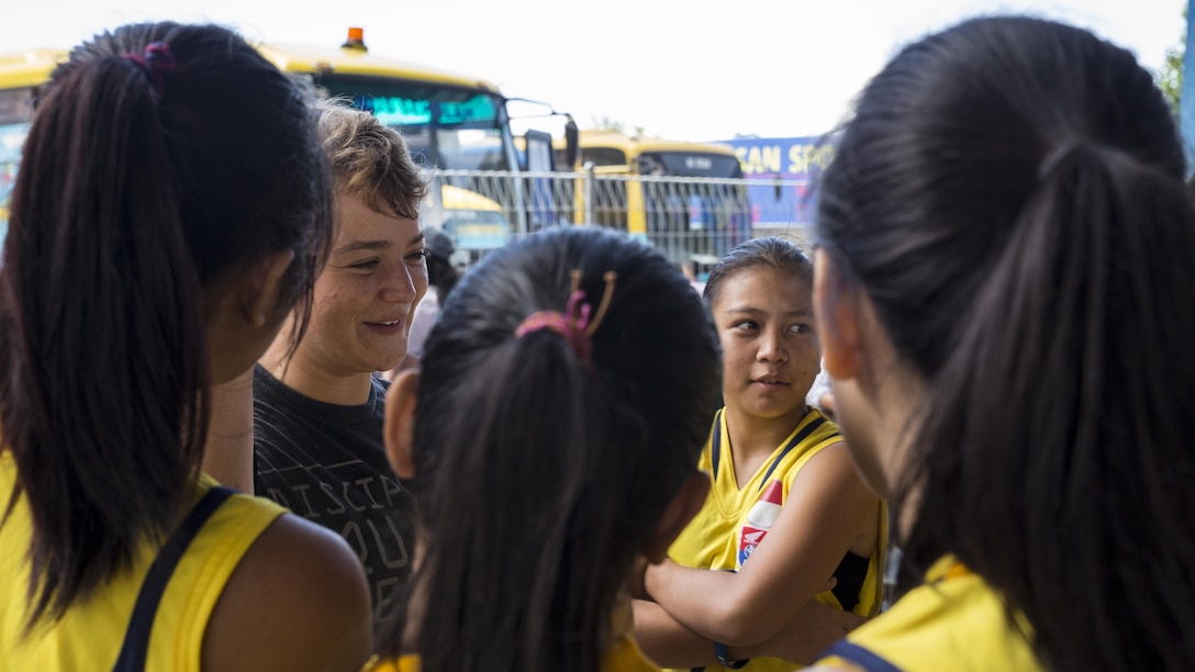 U.S. Marine Corps Lance Cpl. Meagan Baker, a heavy equipment operator with Marine Wing Support Squadron 171, interacts with Sekolah Menengah Eben Haezar Manado High School students in Manado, Indonesia, Nov. 9, 2016. As part of a community relations event, the visit offered service members the opportunity to engage in cultural exchanges and build relationships within the local community. The students were afforded the opportunity to ask the Marines and Sailors questions.
