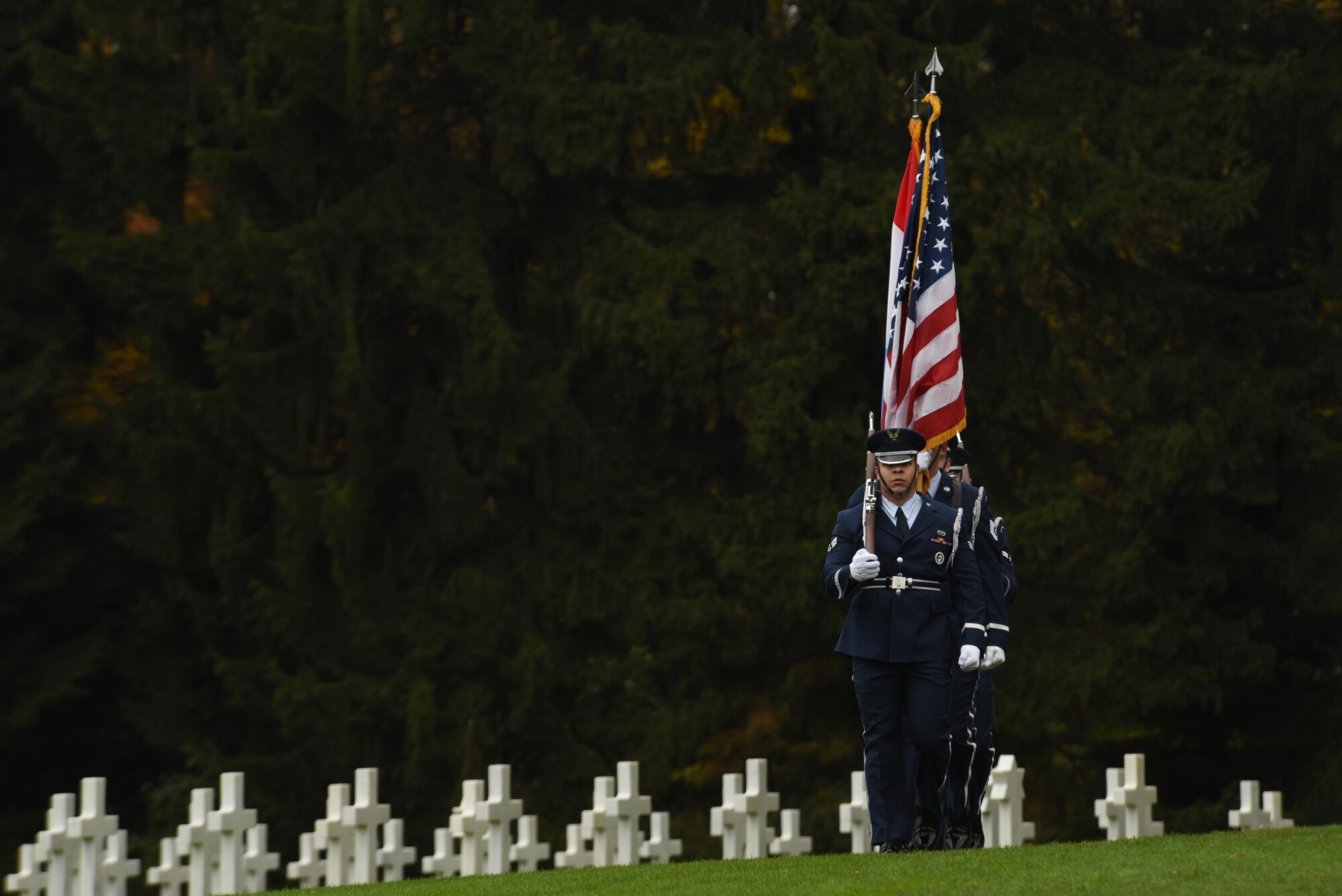Ceremonial guardsmen from the 52nd Fighter Wing, Spangdahlem Air Base, Germany, march while carrying the Luxembourg and American flags during a Memorial Day ceremony at the Luxembourg American Military Cemetery and Memorial in Luxembourg, Nov. 11, 2016. The ceremony paid tribute to the legacy of service of members of the American armed forces. (U.S. Air Force photo by Staff Sgt. Joe W. McFadden)