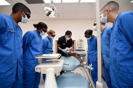 Tech. Sgt. Christy Nixon, Instructor supervisor of the Air Force Dental Assistant Training program, gives students a glimpse of the restorative materials they will work with during training Oct. 20, 2016 at the Medical Education and Training Campus on Joint Base San Antonio-Fort Sam Houston. The dental assistant apprentice course is one of four courses taught at the 381st Training Squadron, a unit of the 59th Training Group. (U.S. Air Force photo/Staff Sgt. Jerilyn Quintanilla) 
