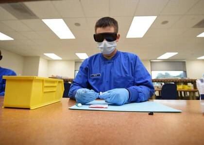 Airman Benjamin Moore, an Air Force Dental Assistant Apprentice Course trainee, mixes Dycal Oct. 20, 2016 at the Medical Education and Training campus on Joint Base San Antonio-Fort Sam Houston. Dycal is used as a defensive barrier to protect the pulp. During training, all students in the course are assigned to the 381st Training Squadron, a unit of the 59th Training Group. (U.S. Air Force photo/Staff Sgt. Jerilyn Quintanilla)