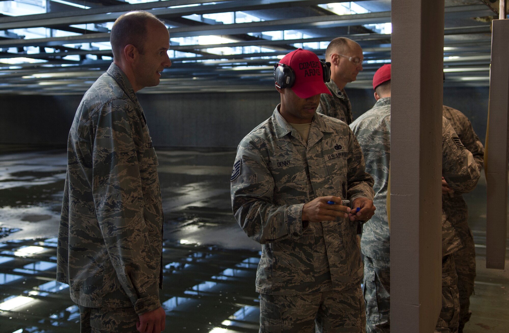 Col. E. John Teichert, 11th Wing and Joint Base Andrews Commander, looks at his target during the 2nd Annual Excellence in Competition, on Joint Base Andrews, Md., Nov. 8, 2016. Service members were broken into relays to allow everyone who signed up the chance to participate and test their marksmanship, with each member shooting 30 rounds from a Beretta M9 pistol. Targets were scored by combat arms instructors, and then compared to determine the best marksman. (U.S. Air Force photo by Senior Airman Mariah Haddenham)