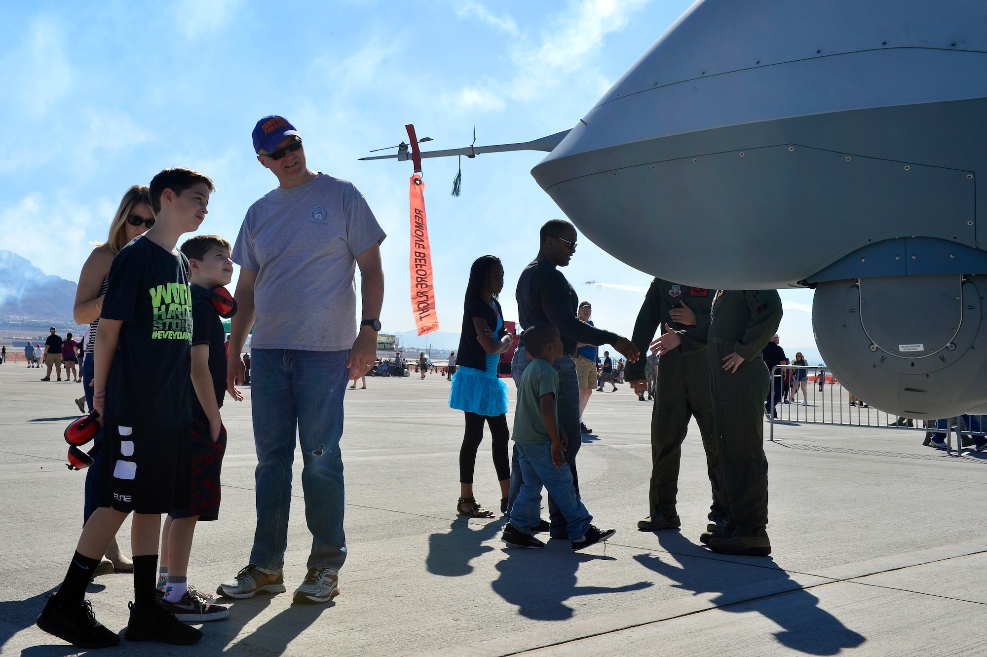 Spectators get a closer look at an MQ-9 Reaper during Aviation Nation Nov. 11, 2016, at Nellis Air Force Base, Nevada. Members from Creech Air Force Base, Nevada, brought an MQ-9 Reaper and MQ-1 Predator to the open house to display its capabilities. (U.S. Air Force photo by Senior Airman Christian Clausen/Released)