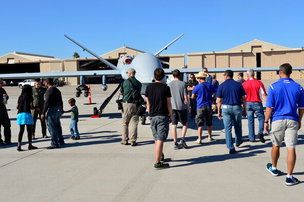 Spectators get a closer look at an MQ-9 Reaper at Aviation Nation Nov. 11, 2016, at Nellis Air Force Base, Nevada. The public was able to get a close view of the aircraft while also being educated on its capabilities from members of Creech Air Force Base, Nevada. (U.S. Air Force photo by Senior Airman Christian Clausen/Released)