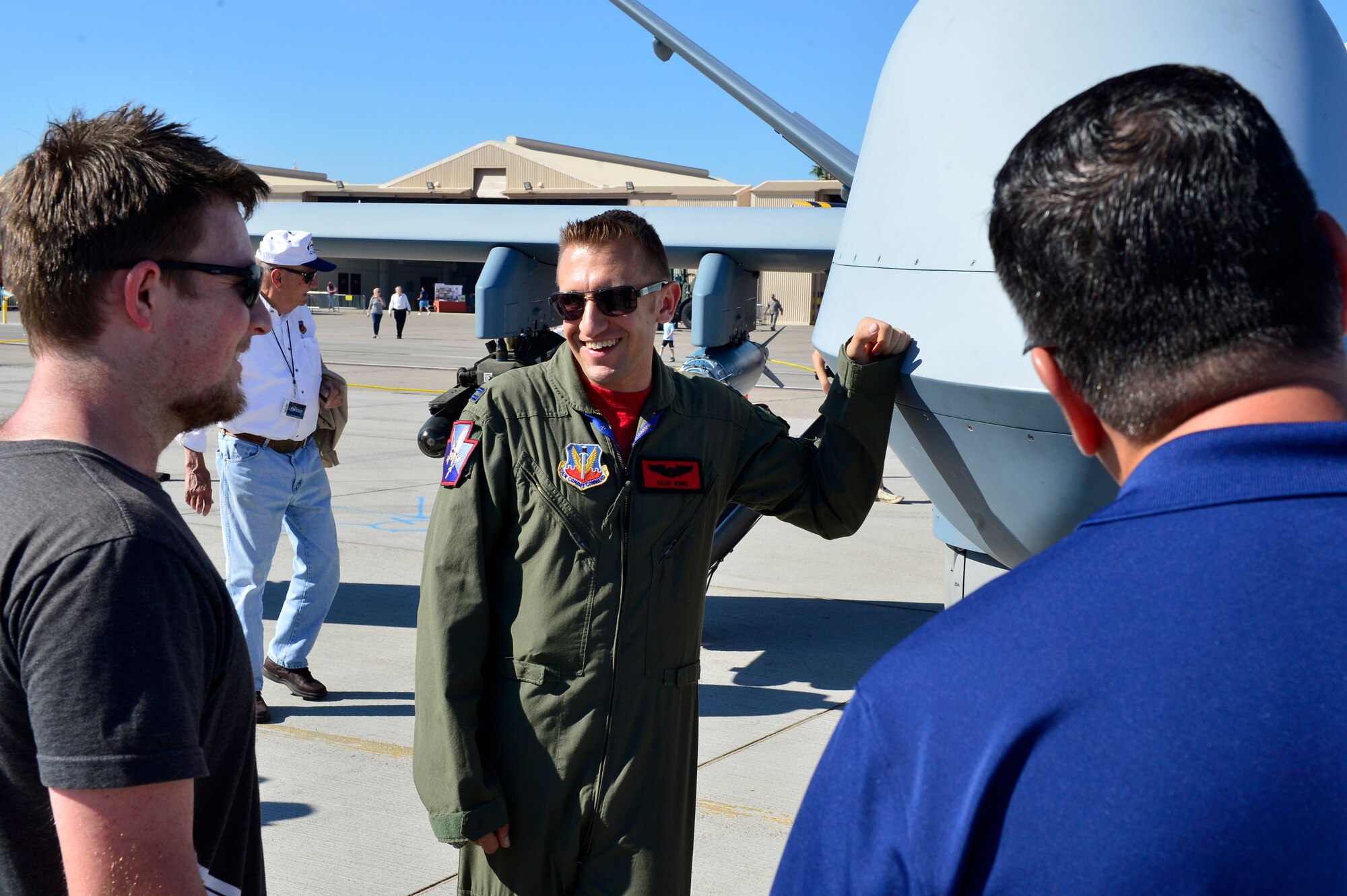 Capt. Michael, 432nd Wing MQ-1 pilot, explains the capabilities of an MQ-9 Reaper during Aviation Nation Nov. 11, 2016, at Nellis Air Force Base, Nevada. The MQ-1 Predator and MQ-9 Reaper were among the many other fighter, bombers, and legacy aircraft on display. (U.S. Air Force photo by Senior Airman Christian Clausen/Released)