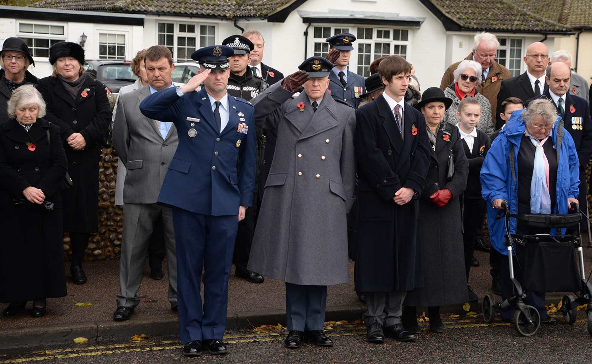 U.S. Air Force Lt. Col. Ryan White, 100th Maintenance Group deputy commander, left of center, and Sqdn. Ldr. Richard Fryer, center, RAF Mildenhall station commander, salute during the playing of “The Last Post” at the Remembrance Sunday parade Nov. 13, 2016, in Mildenhall, England. U.S. Air Force Airmen from RAF Mildenhall took part in the event along with Sea Cadets, Army Cadets, Air Cadets and other groups from the local community. Remembrance ceremonies are held around the U.K. each year on the closest Sunday to Armistice Day, Nov. 11, to honor those who lost their lives in wars both past and present. (U.S. Air Force photo by Karen Abeyasekere)