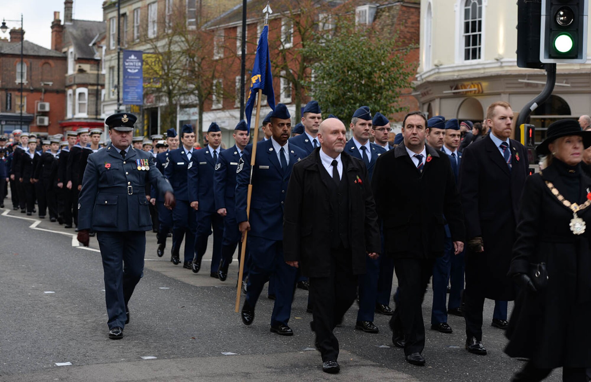 U.S. Air Force Airmen from Team Mildenhall march down the high street during a Remembrance Sunday parade after laying a poppy wreath at the memorial Nov. 13, 2016, in Newmarket, England. Poppies were chosen as a symbol of remembrance because many British soldiers lost their lives in the poppy fields of Flanders, Belgium, during World War I. (U.S. Air Force photo by Karen Abeyasekere)