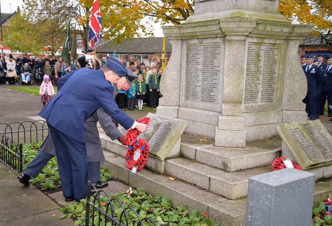 U.S. Air Force Lt. Col. Sean Lewis, front right, 727th Air Mobility Squadron commander, lays a wreath with Sqdn. Ldr. Richard Fryer, front left, RAF Mildenhall station commander, during a Remembrance Sunday ceremony Nov. 13, 2016, in Newmarket, England. Poppies were chosen as a symbol of remembrance because many British soldiers lost their lives in the poppy fields of Flanders, Belgium, during World War I. (U.S. Air Force photo by Karen Abeyasekere)