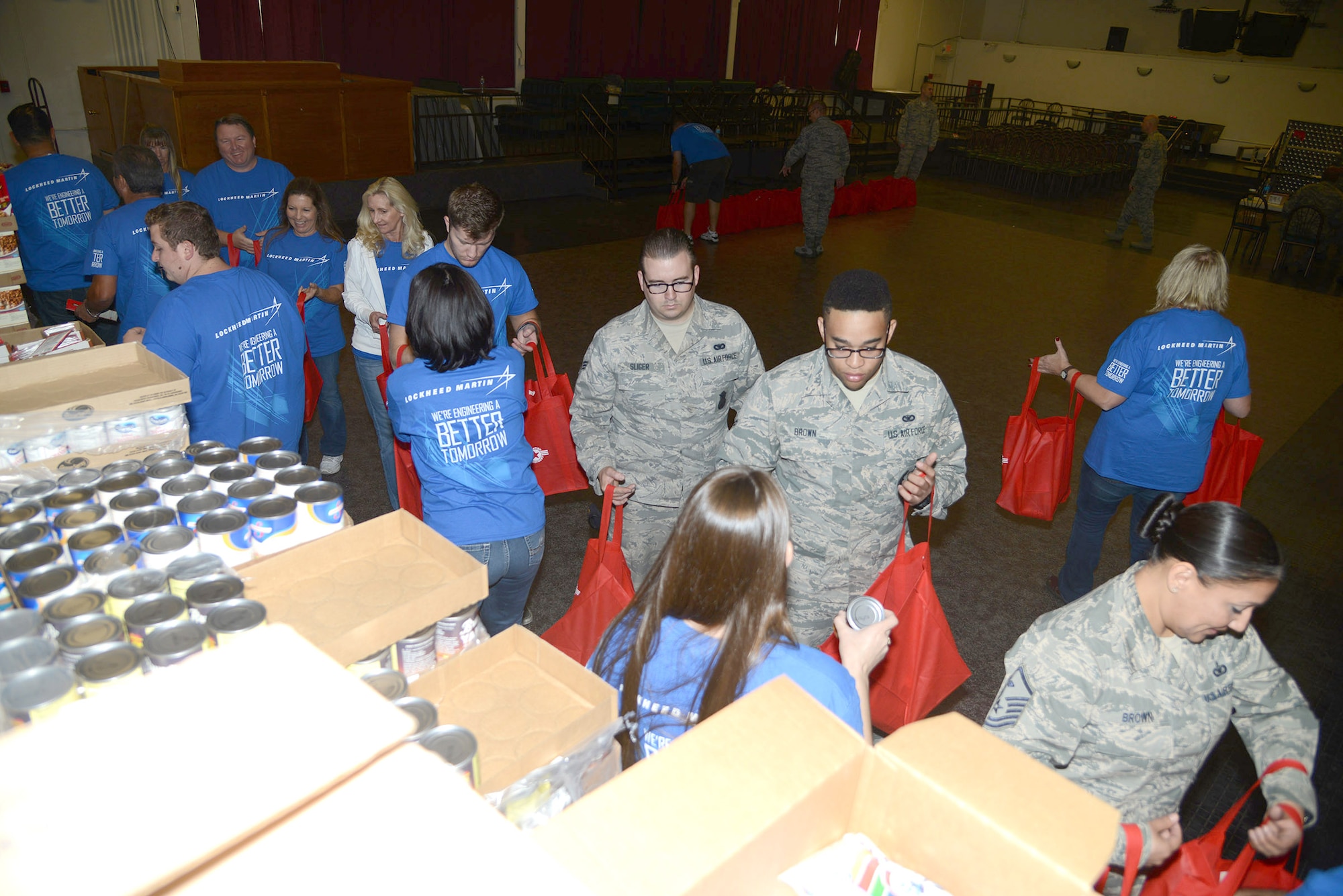 Volunteers from Edwards’ First Sergeants Council and Lockheed Martin prepare Operation Home Front holiday meal gift bags for Edwards families that may need extra help. The bags contained dry goods to create a holiday meal, as well as a $25 Commissary gift certificate to get a turkey or ham, a small AAFES BX certificate, a family game and a movie. 
The First Sergeants Council worked with supervisors across the base to help identify those families that would benefit from some extra holiday help. Lockheed Martin provided finances and volunteers to help with the effort. 
Operation Homefront is a nationwide nonprofit organization that assists military families during difficult financial times by providing food assistance, auto and home repair, vision care, travel and transportation, moving assistance, essential home items, and rent-free transitional housing for wounded veterans and their families. Operation Homefront arranged for approximately 250 meals at Edwards, and will provide more than 1,000 holiday meals in California. (U.S. Air Force photo by Christopher Ball)
