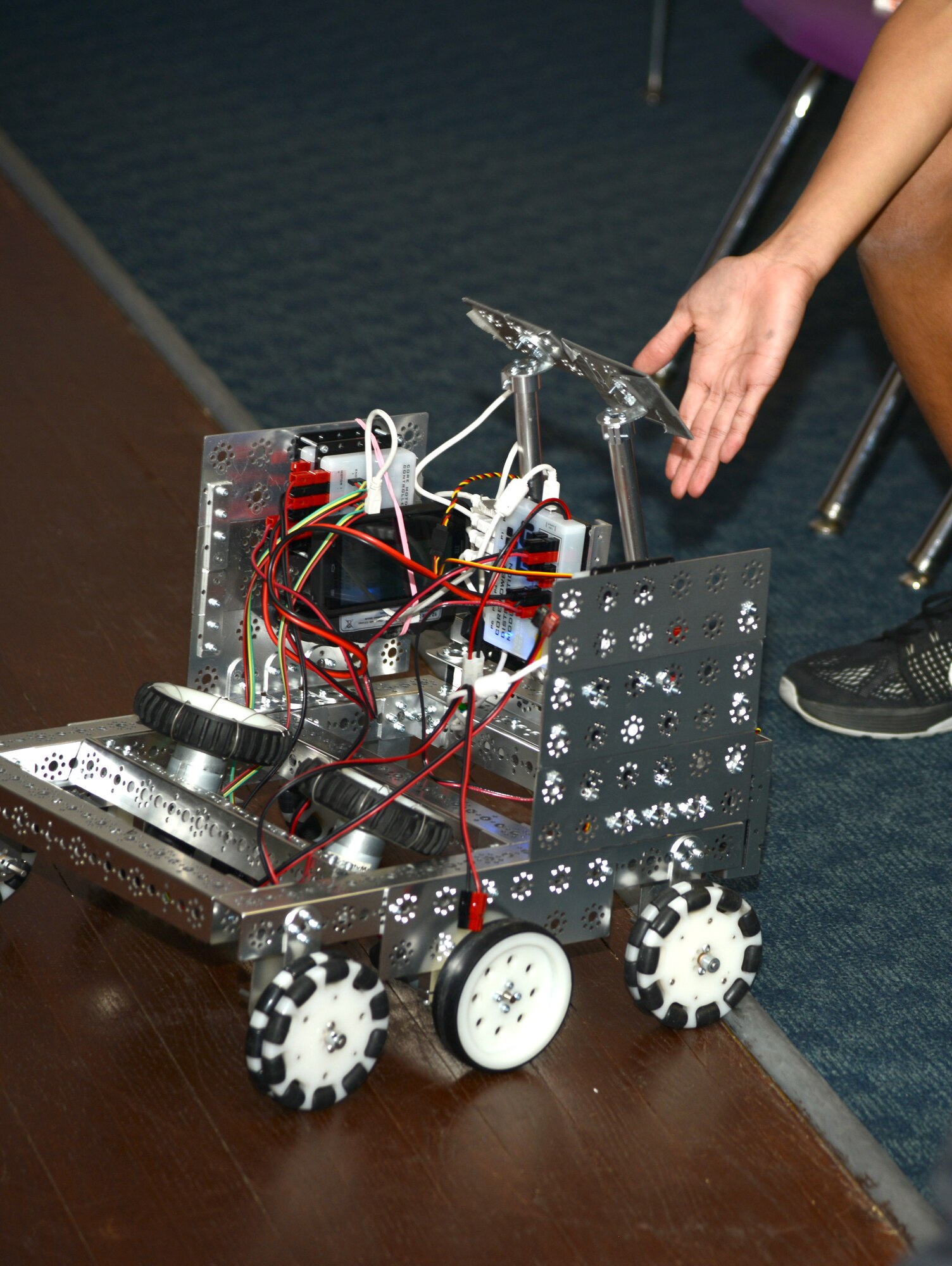 An onlooker at the Edwards Youth Center gets a robotic high five. The robot was one of two displayed and demonstrated by the Desert Junior and Senior High School Robotic Club during and outreach event at the Youth Center Nov. 3. (U.S. Air Force photo by Christopher Ball)