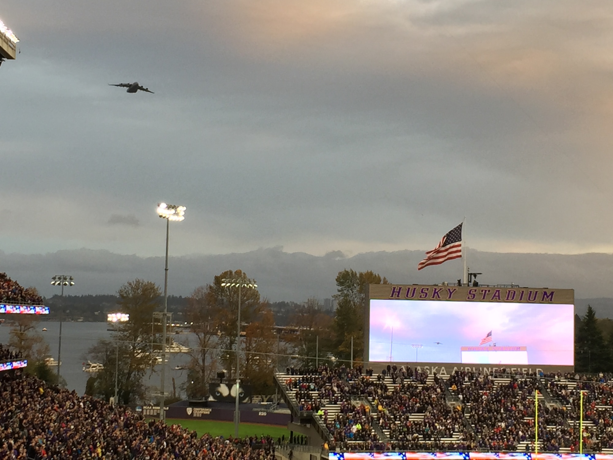 A C-17 Globemaster III piloted by members from the 728th Airlift Squadron flies over the University of Washington Husky stadium during their Veterans Day salute to military members Nov. 12. (Photo by Maj. Brooke Davis)