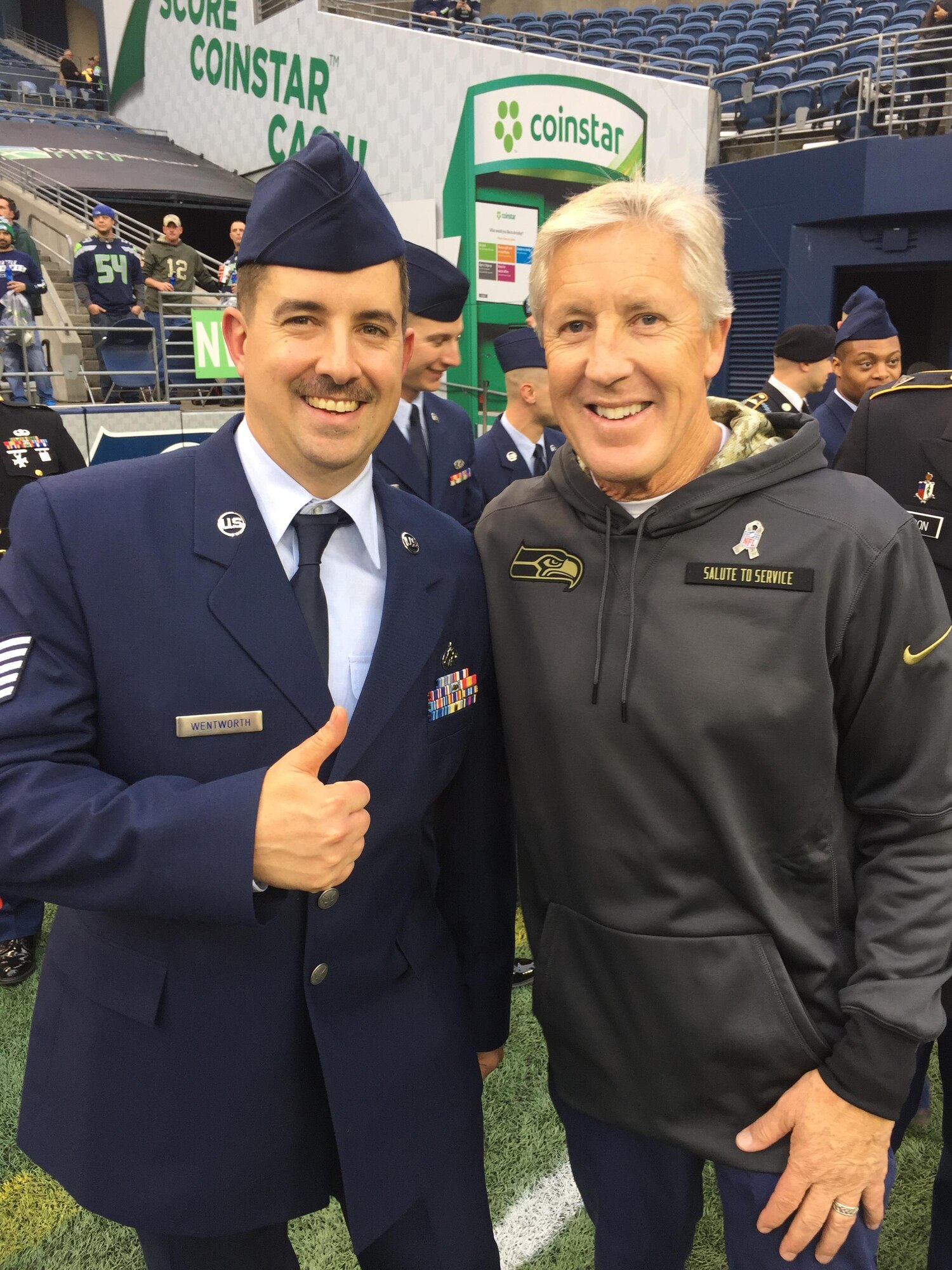 Tech. Sgt. John Wentworth, 446th Aircraft Maintenance Squadron technician meets Seattle Seahawks Head Coach Pete Carroll during the Seakhawks Veterans Day military salute Nov. 7. (Courtesy Photo)