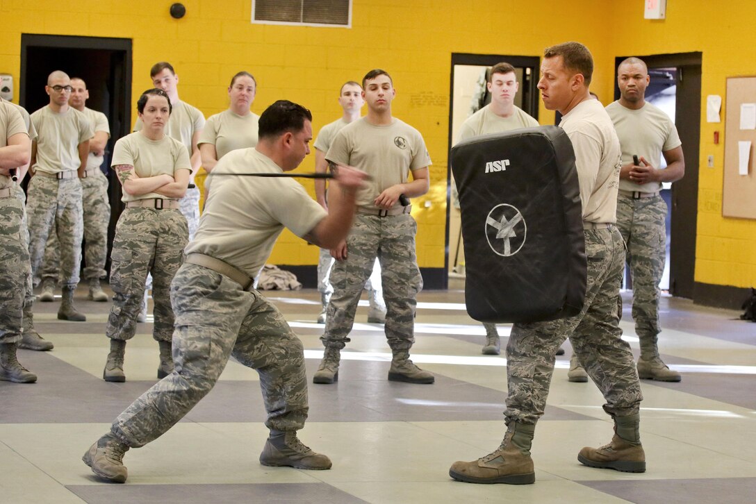 Air Force Master Sgt. Santiago Tapia, left, demonstrates proper technique during less-than-lethal baton skills training at Joint Base McGuire-Dix-Lakehurst, N.J., Nov. 6, 2016. Tapia is assigned to the New Jersey Air National Guard's 108th Security Forces Squadron. Air National Guard photo by Tech. Sgt. Matt Hecht