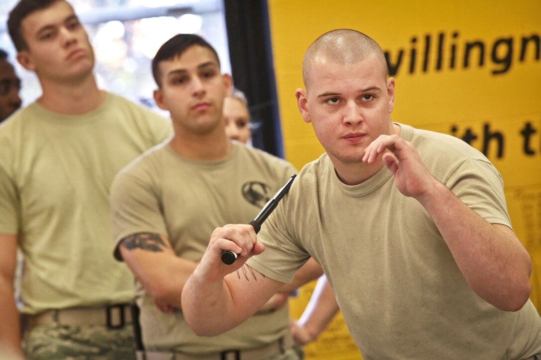 An airman prepares to attack with a training knife during less-than-lethal baton skills training at Joint Base McGuire-Dix-Lakehurst, N.J., Nov. 6, 2016. Air National Guard photo by Tech. Sgt. Matt Hecht