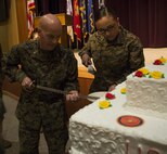 Col. Charles Dunne, commanding officer, Headquarters and Service Battalion, U.S. Marine Corps Forces Command, cuts a slice of cake in honor of the Marine Corps’ 241st birthday at the Joint Forces Staff College aboard Naval Support Activity Hampton Roads, Norfolk, Va., Nov. 9. The first slice of cake is given to the oldest Marine in the unit and the second slice is given to the youngest Marine to symbolize the passing of knowledge and tradition between generations. (Official U.S. Marine Corps photo by Sgt. Calvin Shamoon/ Released)