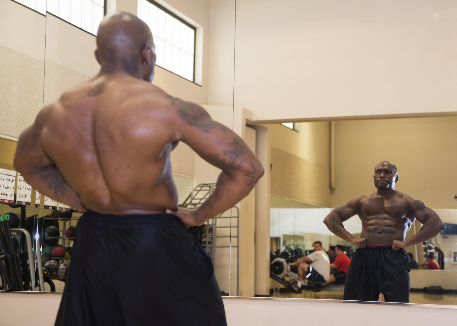 Tech Sgt. Jason Haden, Air Education and Training Command NCO in charge of instructor and support assignments, practices posing in the mirror at the Rambler Fitness Center on Joint Base San Antonio-Randolph Oct. 24, 2016. The purpose of posing is for competitors to showcase their physique’s strong points to the judges and entertain the audience.