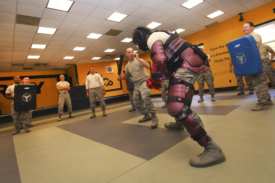 An airman, center left, takes on Air Force Tech. Sgt. Rajhun George, dressed in the red pads, during less-than-lethal baton skills training at Joint Base McGuire-Dix-Lakehurst, N.J., Nov. 6, 2016. George is assigned to the New Jersey Air National Guard's 108th Security Forces Squadron. Air National Guard photo by Tech. Sgt. Matt Hecht