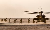 Soldiers with the 77th Armored Regiment, 3rd Brigade, 1st Armored Division, load onto a UH-60 Black Hawk helicopter after completing their iteration of the squad live-fire exercise Nov. 2, 2016 at Udari Range near Camp Buehring, Kuwait. Infantry Soldiers, indirect fire infantrymen and forward observers synchronized their capabilities during thefour-day training event by executing dismounted squad battle drills. (U.S. Army photo by Sgt. Angela Lorden)