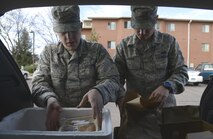 Senior Airmen Joseph Todd and Eric Paradis, both Defense Red Switch technicians with the 21st Communications Squadron, sort through meals Nov. 4, in Colorado Springs, Colo. They volunteered for Meals on Wheels to deliver food to the elderly. (U.S. Air Force photo by Shellie-Anne Espinosa)