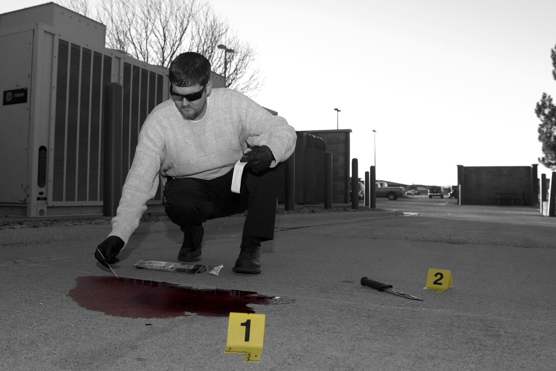 Robert O’Brien, a detective assigned to the 28th Security Forces Squadron, gathers a sample of blood at a simulated crime scene at Ellsworth Air Force Base, S.D., Nov. 10, 2016. Once collected, samples are sent to the U.S. Army Criminal Investigation Labs where they are run for DNA before being sent to the Federal Bureau of Investigation to determine a match. (U.S. Air Force photo illustration by Airman 1st Class Donald C. Knechtel)