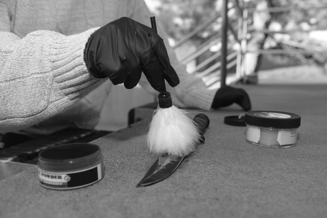 Robert O’Brien, a detective assigned to the 28th Security Forces Squadron, dusts for fingerprints on a knife at Ellsworth Air Force Base, S.D., Nov. 10, 2016. The unique pattern of individual human prints was discovered during the 19th century by Henry Faulds while working as a medical missionary in Japan and is critical to identifying persons when conducting investigations. (U.S. Air Force photo by Airman 1st Class Donald C. Knechtel)

